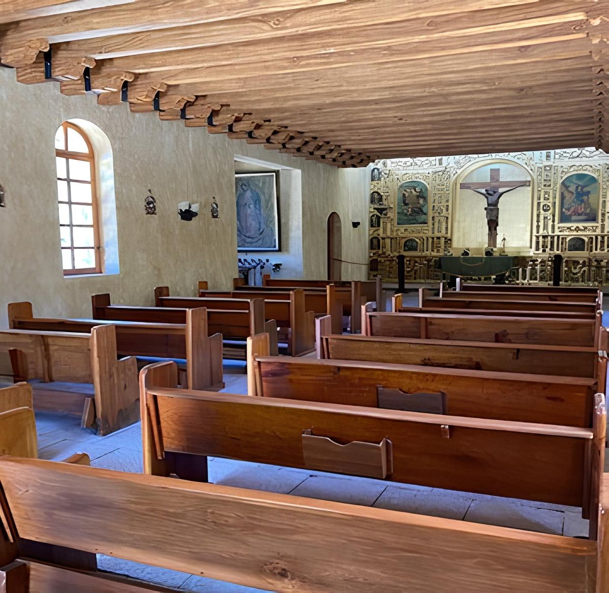 The hacienda chapel interior with wooden pews