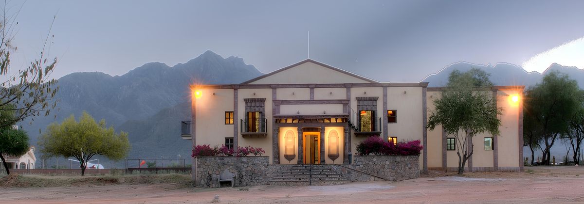 Hacienda de los Santos at dusk with Sierra Madre mountains